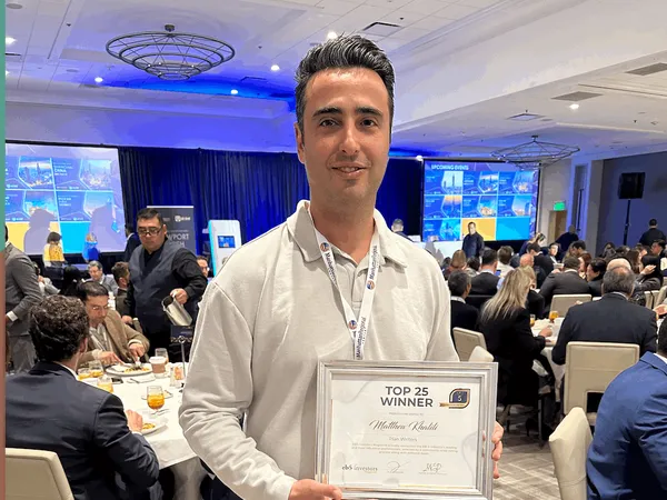 Matthew Khalili receiving Top 25 Winner award at EB5 Investors Magazine conference